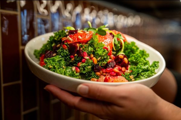 Bowl of fresh kale salad with grapefruit, pomegranate, and seeds at Lunch Counter Cafe Jackson Hole