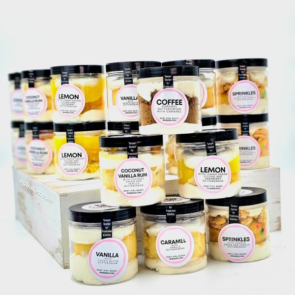 Assorted jar cakes with various flavors like lemon, vanilla, coffee, and sprinkles.