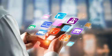 Person using a smartphone with floating digital app icons.