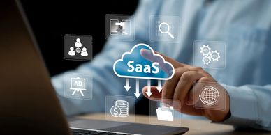 Person interacting with SaaS cloud computing icons on a laptop.