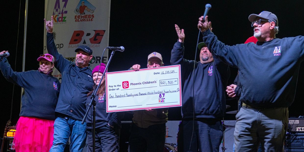 AZ Kids Experience presents check to Phoenix Children's Hospital for $121,000. Now that's a win for 