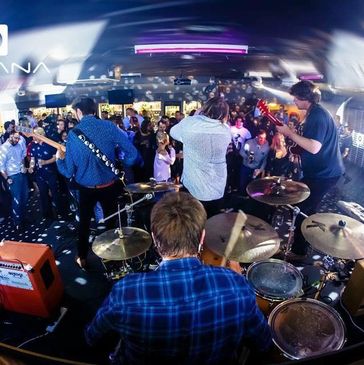 Live band performing on stage at Havana nightclub with an engaged audience.