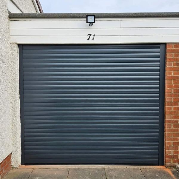 Black roller garage door with number 71 above it.