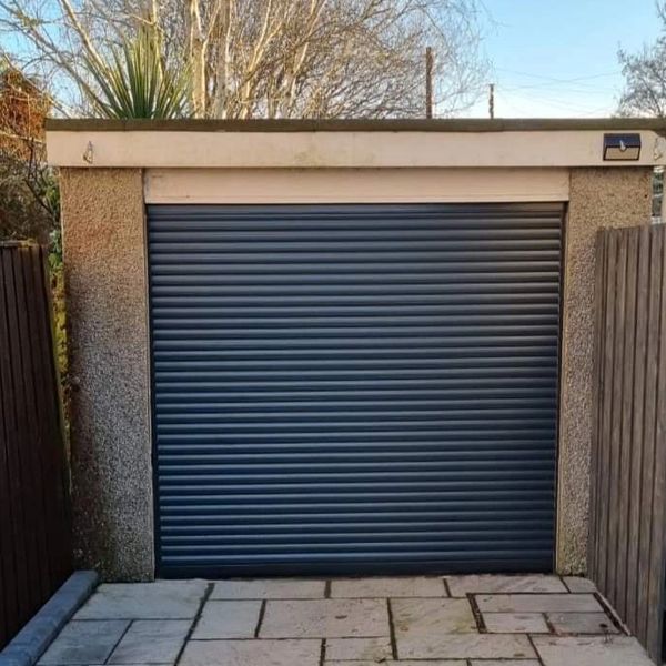 Closed garage door with stone pavement.
