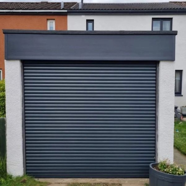 Closed black roller garage door with light frame.