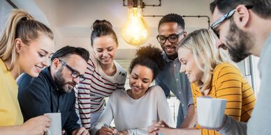 Group of diverse people working over coffee