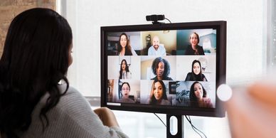 Woman looking at a virtual meeting on a computer screen