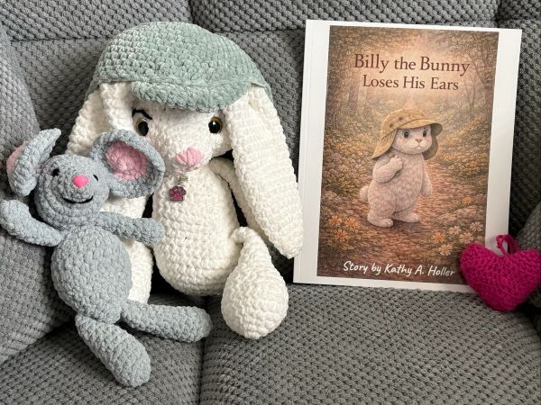 Crocheted bunny and mouse toys with a children's book.