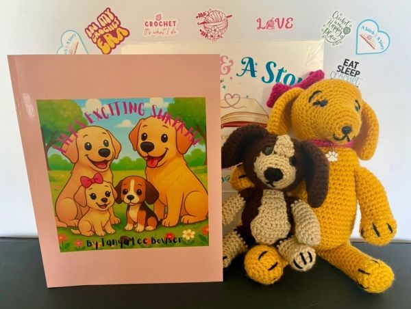 Crochet dog book with two crocheted dog dolls.