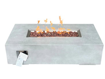 Modern rectangular fire pit with flames and lava rocks.