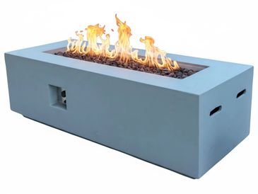 Modern rectangular fire pit with visible flames and stone filler.