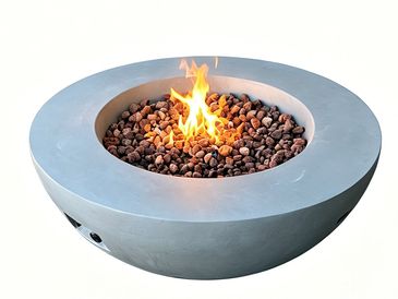 Modern round fire pit with lava rocks and a burning flame.