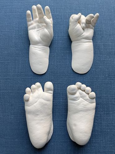 Baby hand and foot casting on a blue blanket