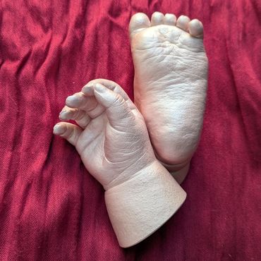 19 week old baby's hand and foot casts coloured in pale pink