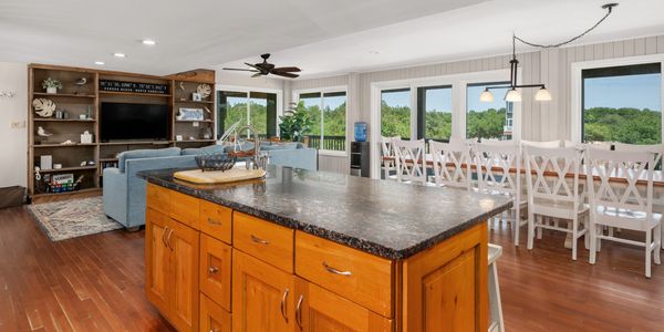 Spacious open kitchen and living area with a large island and dining table.