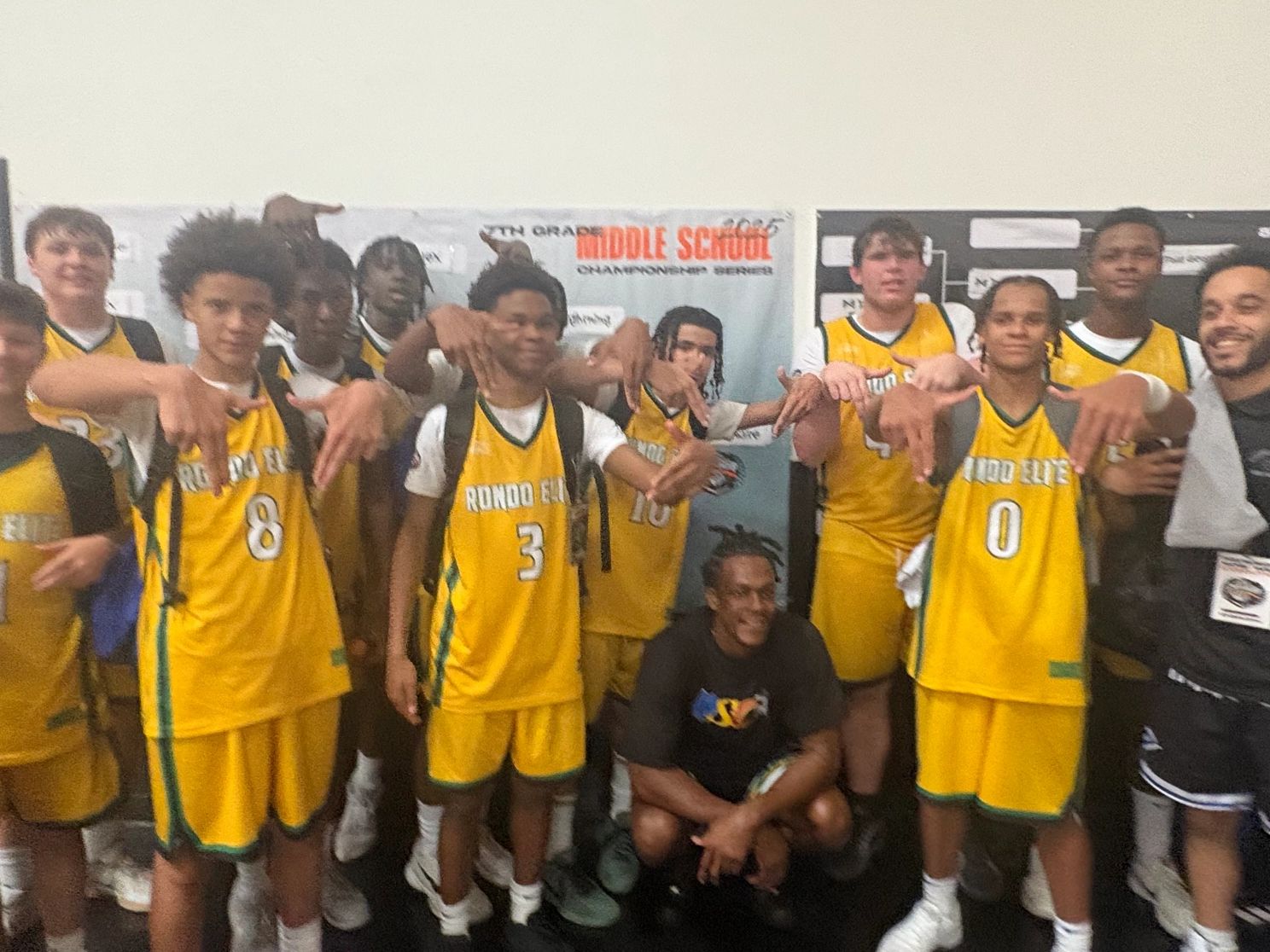 Athletes celebrate after winning championship, holding trophy proudly