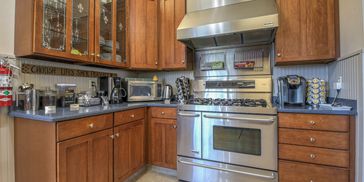 Cozy kitchen corner with wooden cabinets and stainless steel appliances.