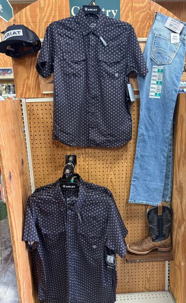 Western-themed display with shirts, jeans, cap, and boots.