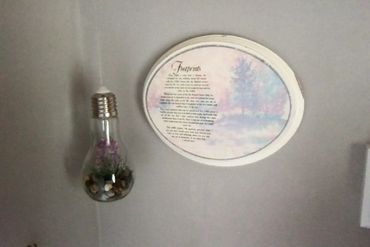 The "Footprints" story and a small light-up terrarium add to the decor in the bathroom.