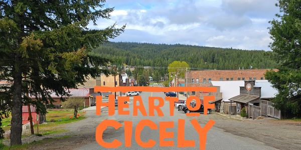 Small town street with 'Heart of Cicely' text overlay.