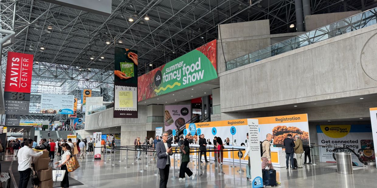 Inside Javits Center at Summer Fancy Food Show registration area.