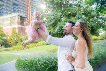 family and baby photo shoot outdoors candid and smiling 