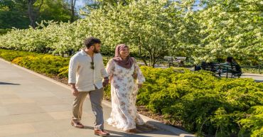 Man and woman walking together in a park.