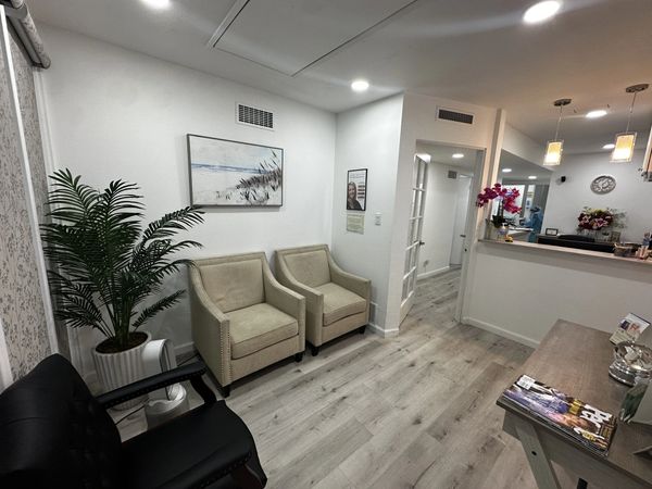 Clean and modern waiting room with chairs and plants.