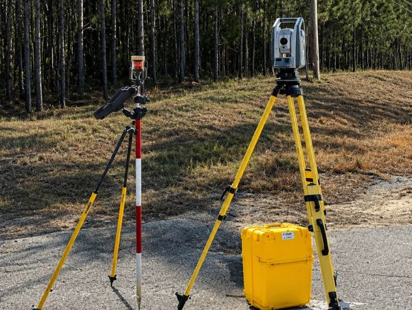 Surveying equipment set up on a roadside.