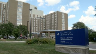Entrance of the VA Medical Center under blue sky.