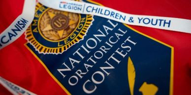 National Oratorical Contest banner with medal and ribbon.