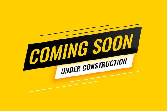 Coming soon under construction sign on yellow background.