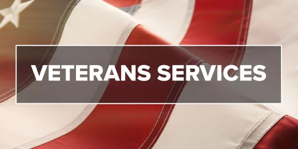 Veterans services announcement on American flag background.