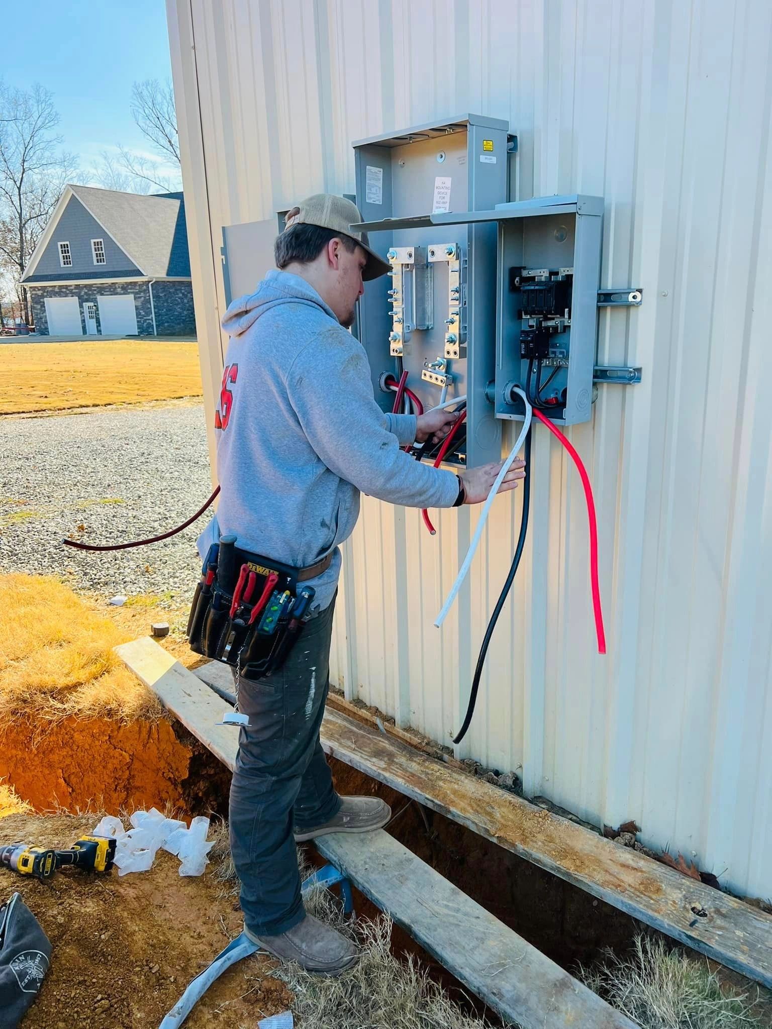 Electrician working on an electrical panel on a construction site.
