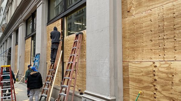 A crew Boarding Up the  store front prior to protests. The emergency board up of all of the windows helped prevent the windows from being broken by vandals and protestors. San Diego Board Up Specialists responds 24 hours a day.