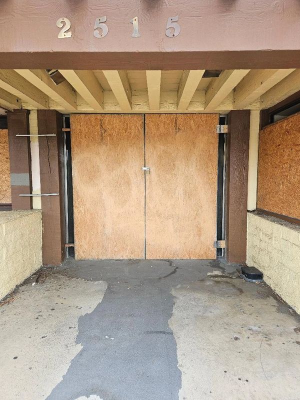 Front door of business Boarded Up