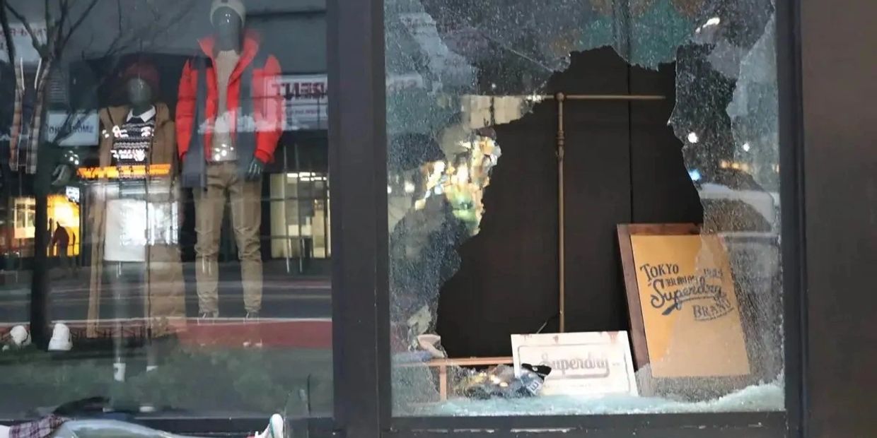 Shattered storefront of business in Oceanside.
