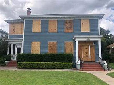 REO/HUD home empty. REO/HUD home boarded up to HUD specifications