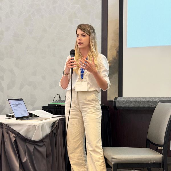 Woman giving a presentation with a microphone.