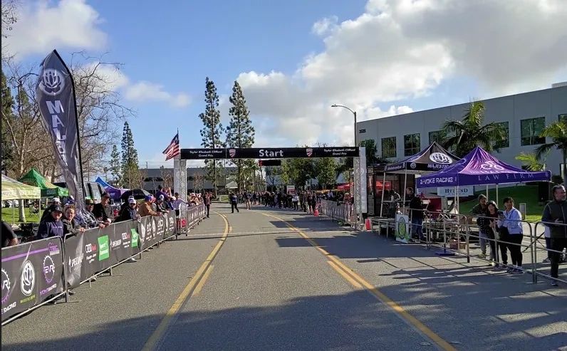 Spectators await cyclists at the start/finish line at the Victor Valley Omnium