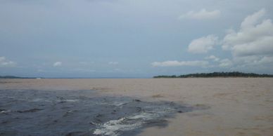 Confluence of Rio Negro and Amazon river near Manaus , Brazil.