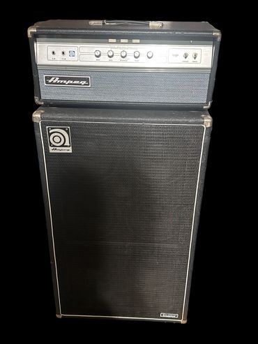 Vintage Ampeg bass amplifier and speaker cabinet with black finish.