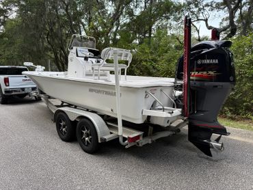 White Sportfish boat on a trailer with a Yamaha motor.