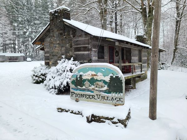 Pioneer Village sign in snow