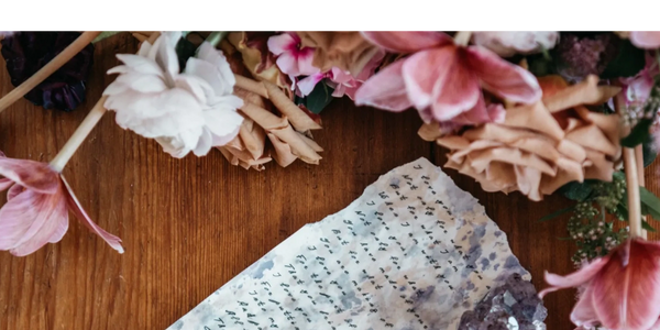 Handwritten wedding vows. Flowers on the table.