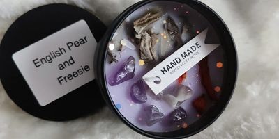 Handmade English Pear and Freesie scented candle with decorative stones.