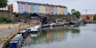 The Harbourside in Bristol. Bristol Talking Therapy Rooms. Colourful buildings and barges.