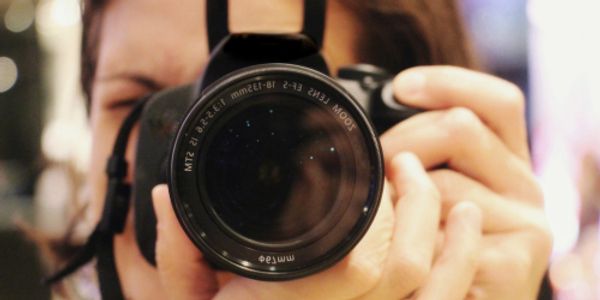 Woman taking a photo close up of the viewer.