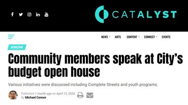 Community members discuss city budget at open house event.