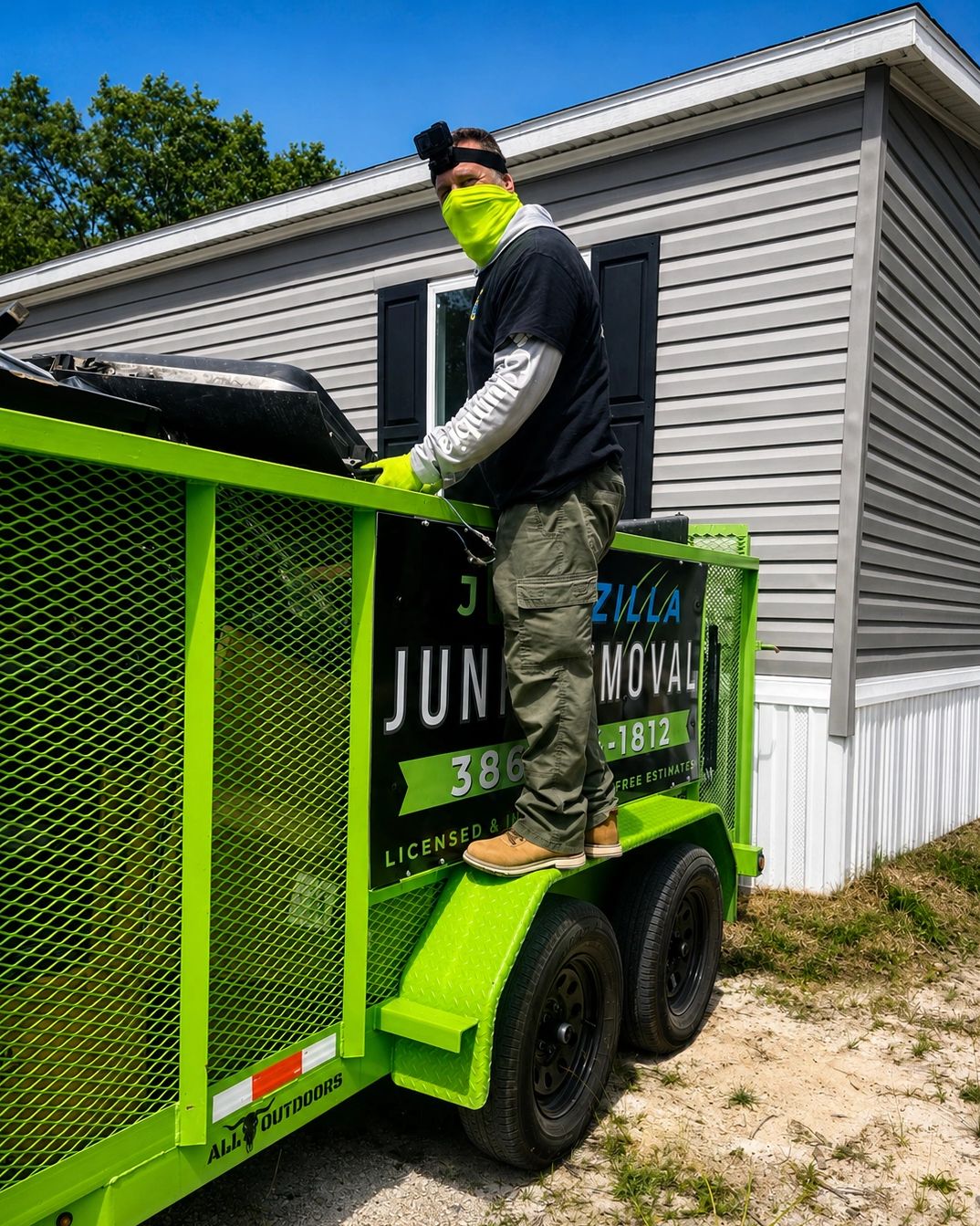 Junk Zilla team member loading the trailer  during an eviction cleanout in Bunnell, FL